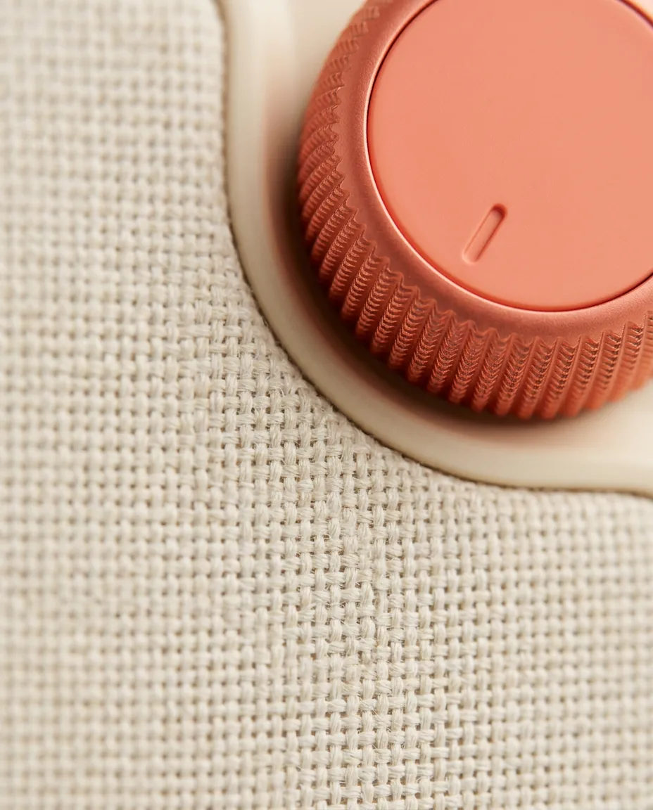 Close-up of the radio’s woven grille and coral dial